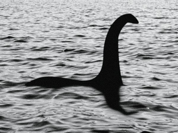 Black and white image of a long-necked, serpent-like figure emerging from rippling water, often associated with the Loch Ness Monster legend.